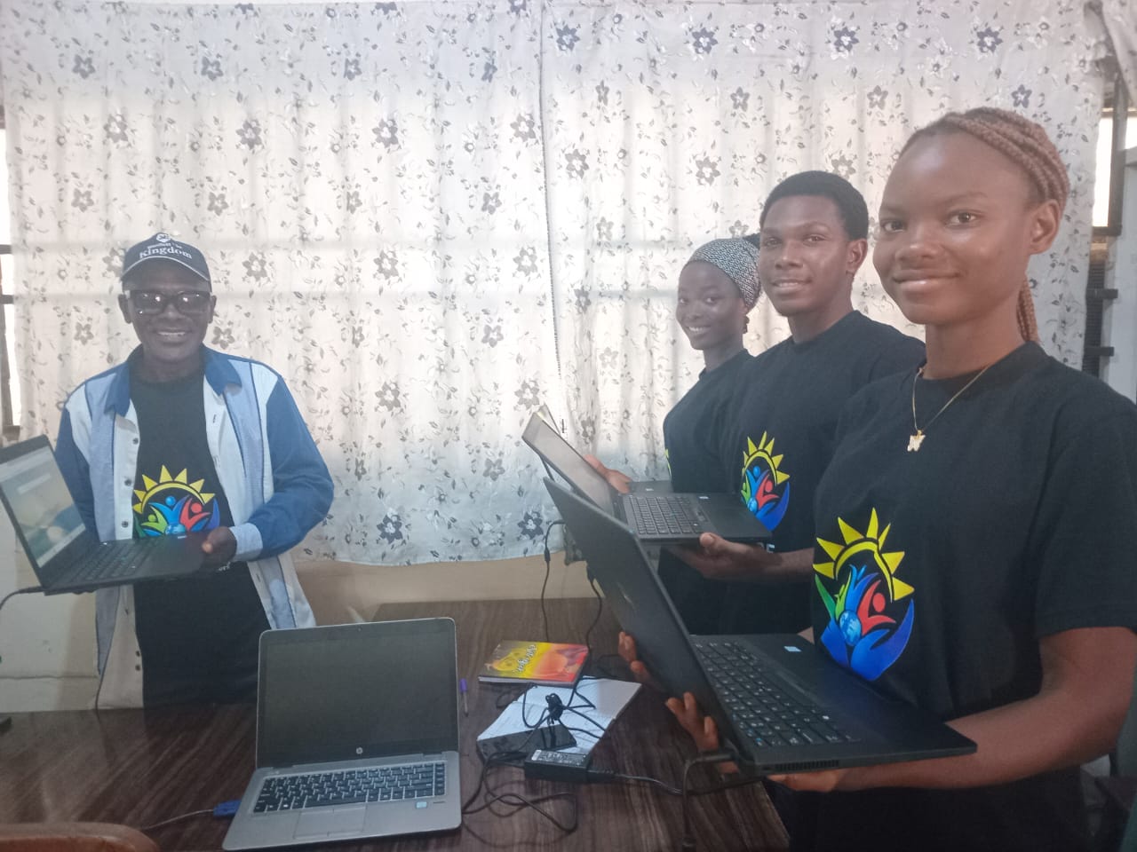 Web Development students holding their new laptops on Day 2