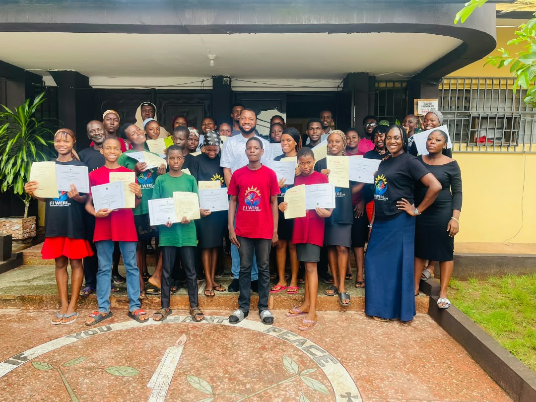 ICT Boot Camp graduates holding their certificates at the closing ceremony