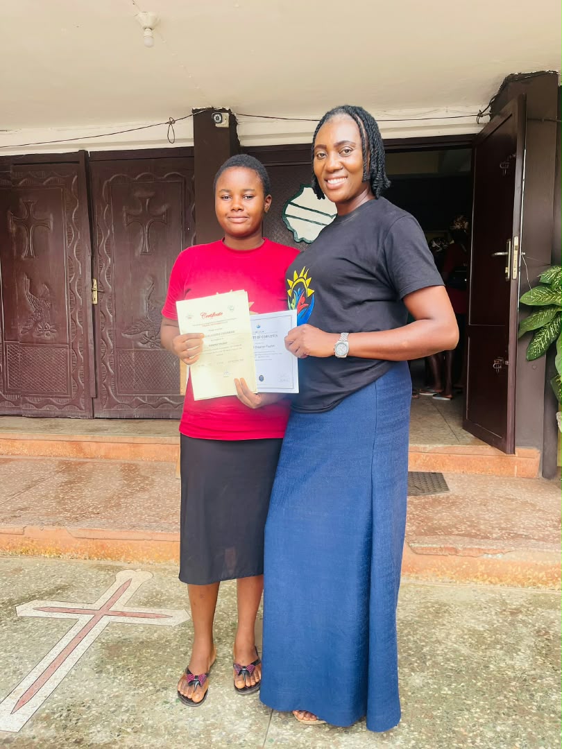 Florish Chizaram Ndubuisi receiving her certificates alongside Charity Ani